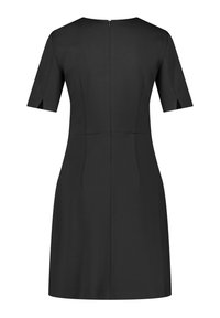Robe noire à manches courtes, dotée d'un col rond et d'une fermeture éclair au dos. Texture lisse et coupe ajustée.