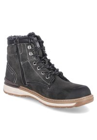 Zwarte enkelboot met vetersluiting en zijklep, witte stiksels, bruine rubberen zool en bontvoering, ontworpen voor koud weer.