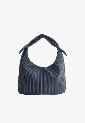 Soft blue fabric shoulder bag with narrow white and beige vertical stripes and knotted straps on a white background.