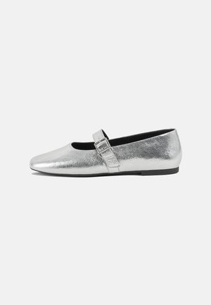 Silver metallic ballet flats with a pointed toe and a side buckle closure. Smooth texture, low black heel, minimalist design.