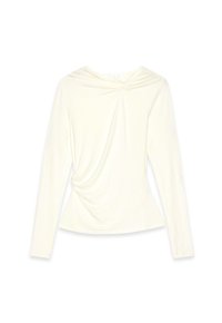 Long-sleeve cream blouse with gathered twist detail at neckline and side, made of soft, stretchy fabric.