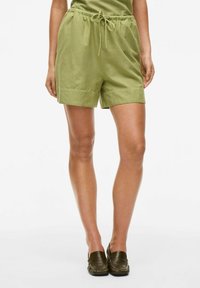 Grønne, letvægts shorts med elastisk talje og snøre. Har en afslappet pasform, sidelommer og en glat stoftekstur.