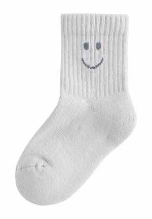 Szara bawełniana skarpeta o prążkowanej fakturze; z prostym, wyszywanym uśmiechniętym buźką w ciemnoszarym kolorze na zewnętrznej stronie. Krótka, do kostki.