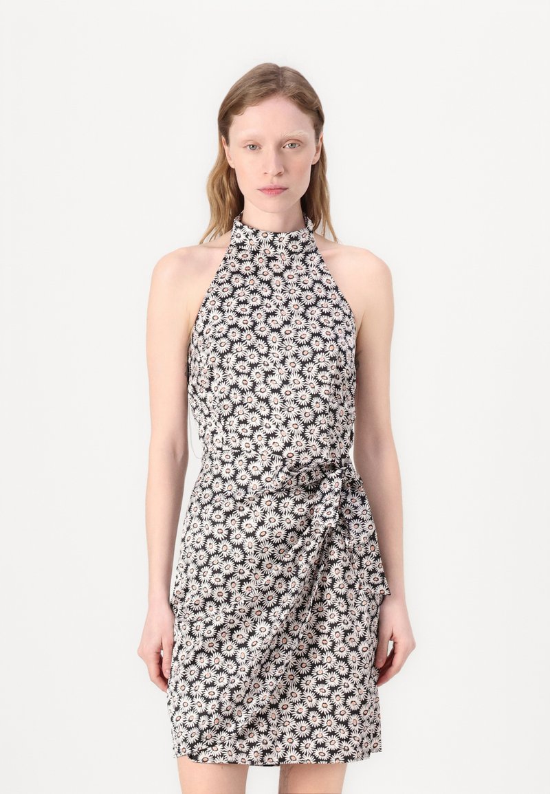 Floral halter-neck dress in black with white and pink daisies. Features a fitted silhouette and a knotted detail at the waist.