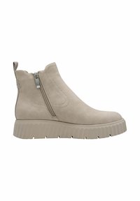 Bottine beige avec une semelle épaisse nervurée, une fermeture éclair sur le côté, une languette à l'arrière et une finition mate lisse.