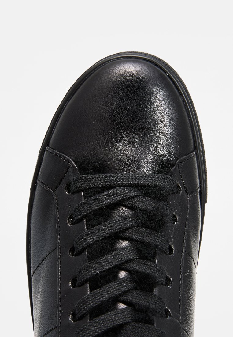 Schwarze Ledersneaker mit glatter Oberfläche, runder Zehenpartie und flachen Schnürsenkeln. Verfügt über dezente Nähte und ein minimalistisches Design.