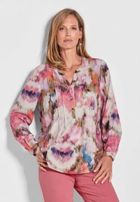 Leichtes, mehrfarbiges Blusenshirt mit floralem Muster, mit V-Ausschnitt, drei Knöpfen, langen Ärmeln und lockerer Passform.
