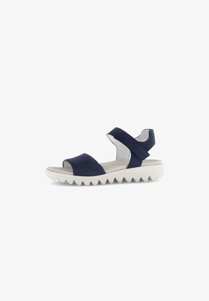 Navyblaue Sandalen mit einem breiten oberen Riemen und einem Riemen an der Rückseite, ausgestattet mit einer strukturierten weißen Sohle mit Zickzackmustern für besseren Halt.