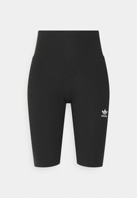 Svarta ribbade cykelshorts med hög midja från Adidas och vitt treklöverlogotyp på vänster lår mot en enkel vit bakgrund.