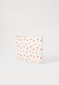 Quilted cosmetic pouch in cream fabric with red heart patterns. Features a top zipper closure and flat rectangular shape.