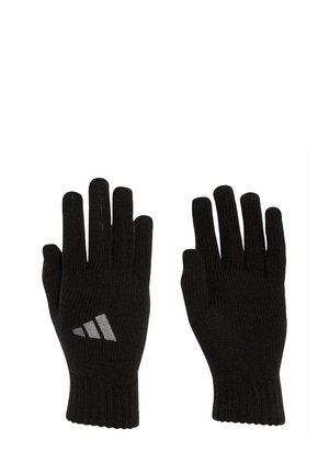 Gants tricotés noirs avec des poignets côtelés, arborant un logo gris réfléchissant sur la paume. Conçus pour la chaleur et la flexibilité d'ajustement.