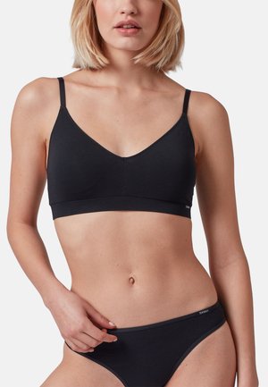 Black bralette featuring a V-neck design and thin adjustable straps. Made from smooth fabric, with minimal seams and a clean silhouette.