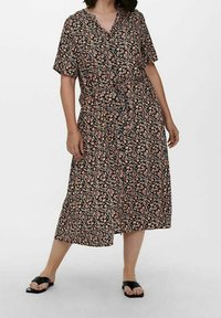 Floral midi dress with short sleeves, black background, small pink and blue flowers, and a tie waist. Smooth fabric, relaxed fit.