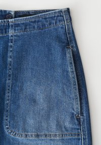 Jean en denim bleu clair avec une finition texturée, présentant des coutures jaunes, une fermeture à bouton supérieur et un design de poche avant.