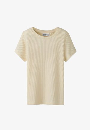 T-shirt a maniche corte in tessuto a coste di colore crema chiaro. Presenta una scollatura rotonda e un tessuto strutturato. Nessun motivo o decorazione visibile.