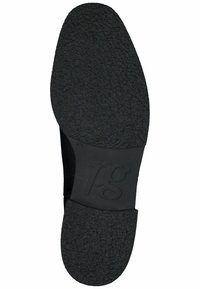 Suela de zapato de goma negra con superficie de agarre texturizada. Presenta una forma circular y un logo de marca visible "pg" en una sección lisa.