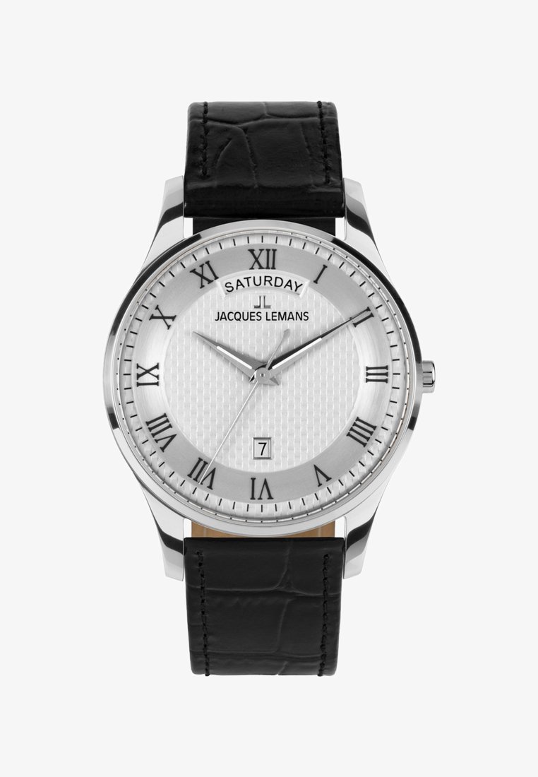 Reloj analógico plateado con números romanos negros, correa de cuero negra, día "Sábado" y fecha "7" mostrados, manecillas marcando las 10:10:40.