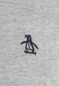 Gray sweater fabric featuring a dark blue embroidered penguin logo on the left side. Material appears soft with a smooth texture.