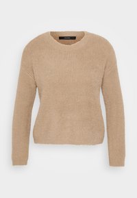 Beige kötött pulóver hosszú ujjakkal, kerek nyakkivágással és puha, textúrált anyaggal. Lazább fazonú és bordázott kialakítású.