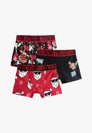 Three pairs of holiday-themed boxers: black with Santa characters, red with Santa faces, and a dark box with a reindeer graphic. All have red elastic waistbands.
