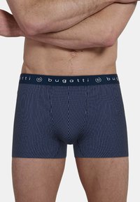 Navy striped men's boxer briefs with a soft elastic waistband featuring the brand name "bugatti" in white lettering. Close-fitting design.