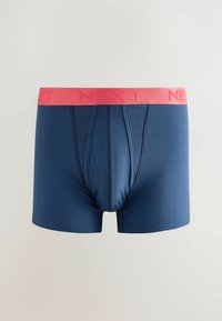 Tengerészkék boxer alsónadrág rózsaszín gumipánttal, amelyen vastag betűkkel a "NEXT" felirat olvasható. Simaságú anyag, előformázott első zsebbe.