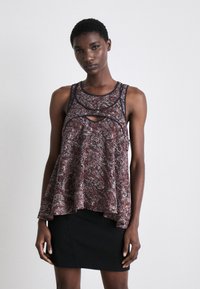 Top sans manches à motif floral avec une coupe évasée, présentant un détail découpé au niveau du décolleté et des bretelles foncées contrastantes.