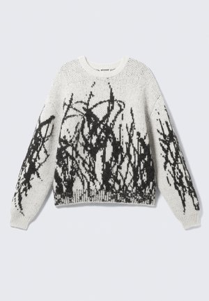 Knit puloveris balts ar melnu grafisko rakstu. Apvieno apļa kaklu, garas piedurknes un ribotu apakšmalu. Mīksta tekstūra.