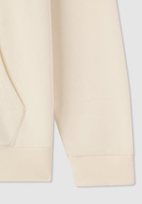 Felpa color beige chiaro in tessuto con polsini a costine, tasca laterale e texture liscia, caratterizzata da un design semplice e pulito.
