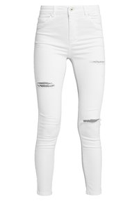 Jeans blancos de tiro alto con un ajuste slim. Presentan roturas desgastadas en las rodillas y un diseño de cinco bolsillos. Hechos de mezclilla.