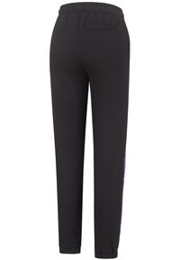 Black jogger pants with an elastic waist, tapered fit, side pockets, and a purple logo detail on the left side. Cotton blend material.