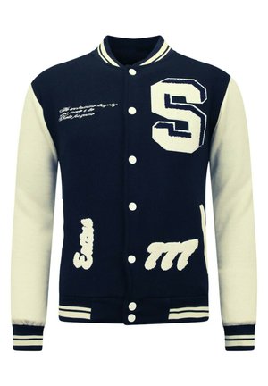 Marineblauwe varsityjack met crèmekleurige mouwen, voorzien van een geborduurde "S" en witte letters. Knopsluiting aan de voorkant en gestreepte ribgebreide boorden.