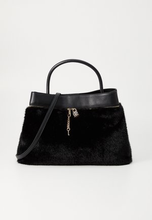 Sort taske i kunstpels med læderdetaljer, top håndtag, skulderrem og guldfarvet lynlåstrækker med hængelås- og nøglevedhæng.