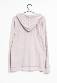 Sweatshirt à capuche long à manches longues de couleur violet clair suspendu sur un cintre noir, vu de l'arrière sur fond blanc.