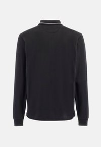 Svart långärmad polo skjorta med krage. Har en kontrasterande vit rand på kragen. Mjuk bomullsmaterial. Enkel design.