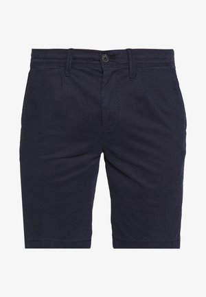 Pantalones cortos de color azul marino hechos de algodón con una textura suave, que presentan un cierre de botón y dos bolsillos laterales para mayor funcionalidad.