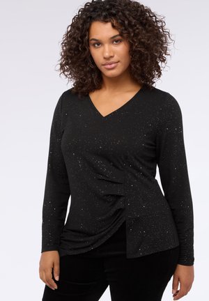 Schwarzes langärmliges Shirt mit V-Ausschnitt, das seitliche Raffung und verstreute silberne Sprenkel im Stoff aufweist. Weiche Textur.