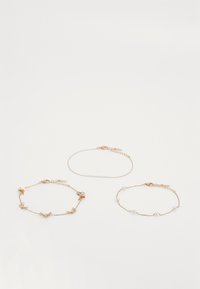 Three gold-tone chain bracelets: one with butterfly accents and crystals, one with a single row of beads, and a delicate plain chain.