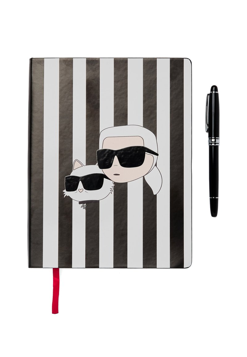 Black and white striped notebook featuring cartoon characters with sunglasses. Includes a red ribbon bookmark and a black pen beside it.