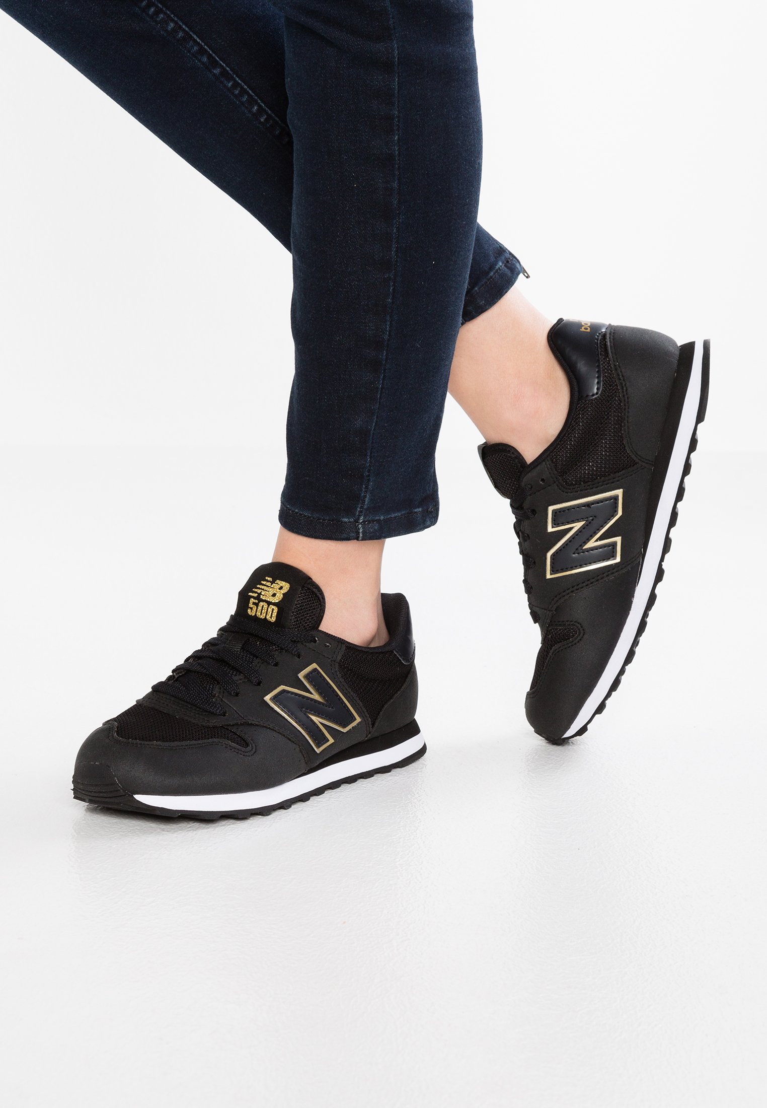 new balance trainers black and gold