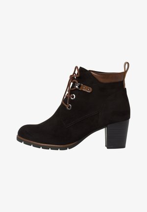 Black suede ankle boot with a brown leather accent, lace-up design, silver eyelets, and a chunky black heel. Textured finish, no patterns.