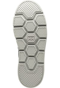 Suela de zapato con un patrón hexagonal, superficie texturizada y un logo central. Predominantemente gris con acentos en gris oscuro. Material de goma duradera.
