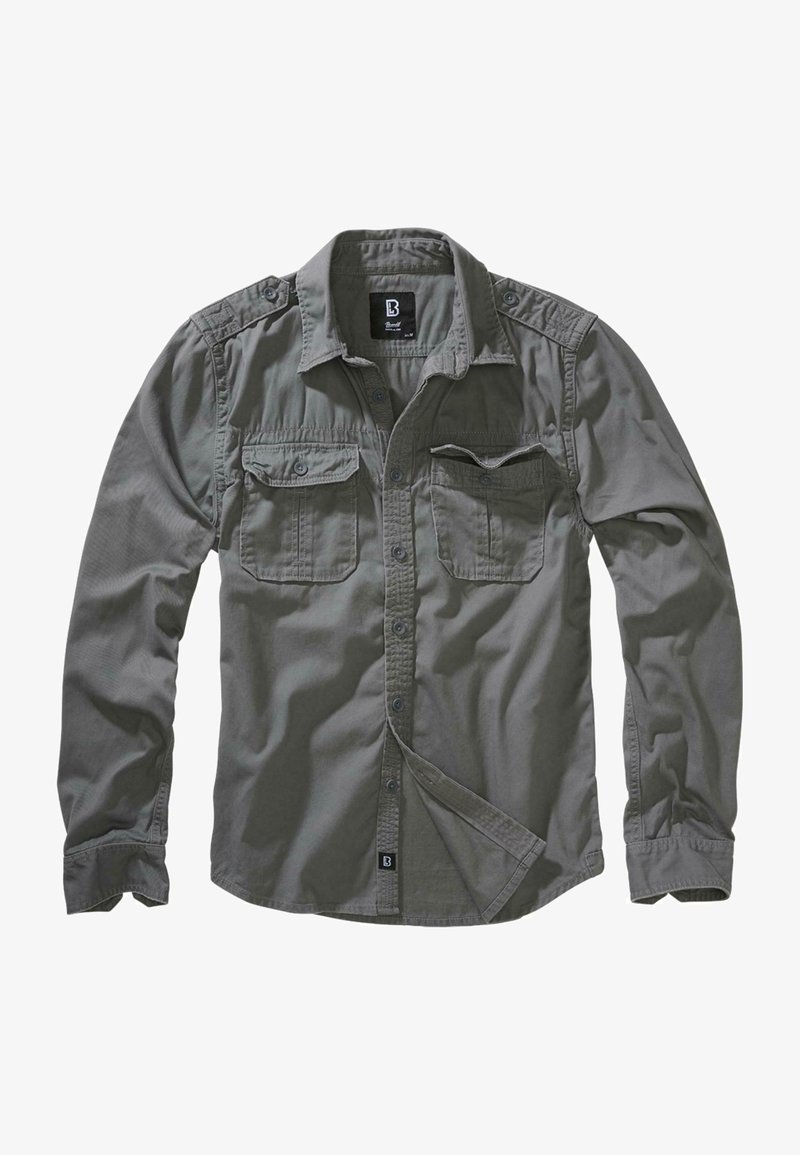 Chemise à manches longues grise, en coton, avec deux poches poitrine, épaulettes, ourlet arrondi, texture lisse et boutons bleus.