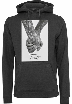 Dark gray hoodie featuring a front graphic of hands holding a flower, detailed with black and gray tattoos, and the word "Trust" below.