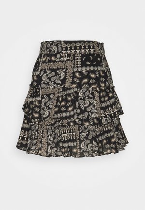 Jupe noire à volants avec un motif cachemire beige et crème, comportant plusieurs couches et une taille ajustée pour une silhouette fluide.