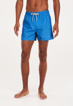 Pantaloni da nuoto blu realizzati in tessuto leggero, con una cintura elasticizzata e un cordino beige, oltre a una piccola etichetta con il logo del marchio.