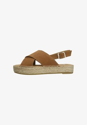 Braune Wildleder-ESPADRILLE-Sandale mit Kreuzriemen und Knöchel-schnalle. Jutewickelsohle, flacher Absatz und offenem Zehenbereich.