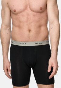 Svarta boxerkalsonger med en grå midjeresår, med svart text som säger "Phil & Co." Slät tyg med en åtsittande design.