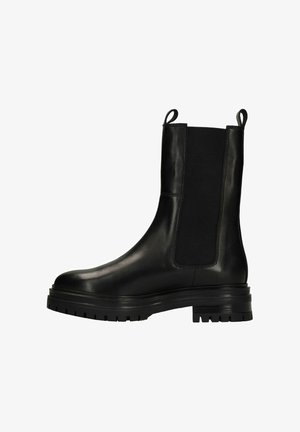 Black leather Chelsea boot with thick lug sole, elastic side panel, and pull tabs at top, shown in side profile on white background.
