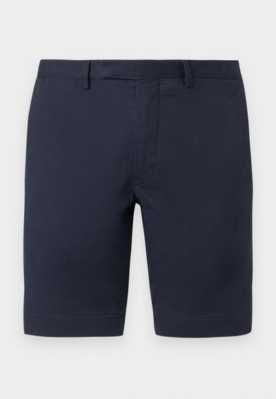 Σομόν σορτς σε ναυτικό μπλε με θηλιές για ζώνη και εμπρόσθιο φερμουάρ, σχεδιασμένα για περιστασιακή ή ημι-επίσημη χρήση.